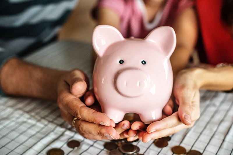 Family holding piggy bank